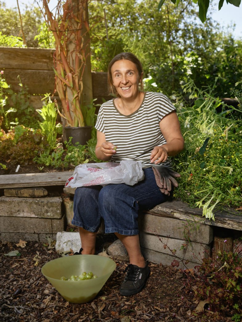 Sabrina trimming gooseberries, Brockwell Park Community Greenhouses