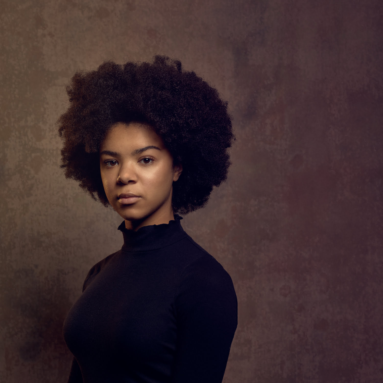 Selective focus on hair. Portrait of a young afro woman with box